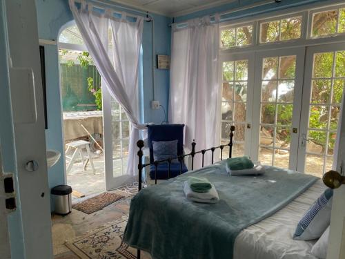 a bedroom with a bed and a large window at Port Nolloth Beach Shack in Port Nolloth