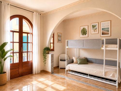 a bedroom with a bunk bed and a door at Torre Florio in Campofelice di Roccella