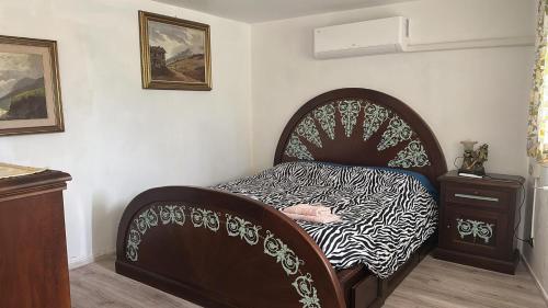 a bedroom with a bed with a zebra print sheets at The Luff & Match B&B in IDRO