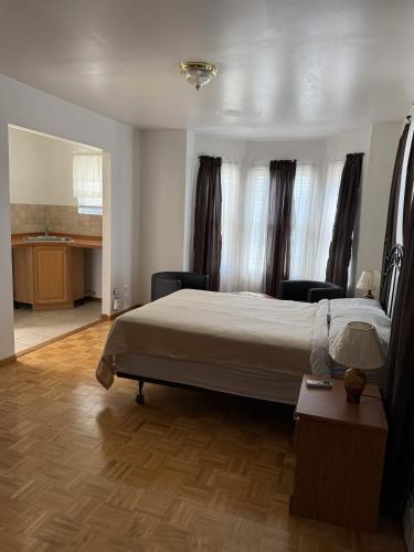 a bedroom with a large bed and a kitchen at ERV Club - Villas in Lixouri