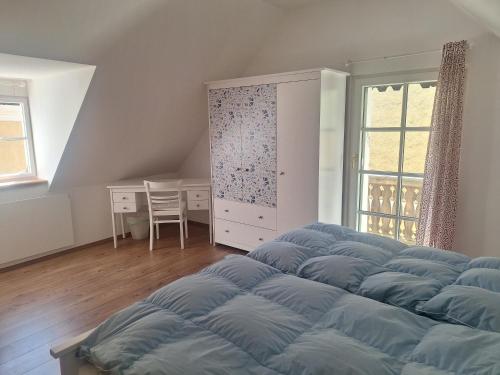 a bedroom with a large bed and a table at Schwarze Gräfin in Spital am Pyhrn