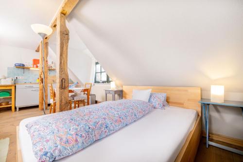 a bedroom with a bed with a wooden head board at Gutshaus Ketelshagen in Putbus