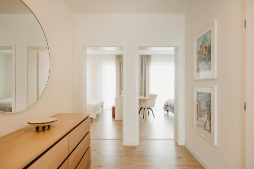 a white room with a large mirror on the wall at Aria Apartments in Prievidza