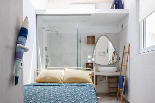 a bedroom with a bed and a sink and a mirror at Cosy 21 in Ialysos