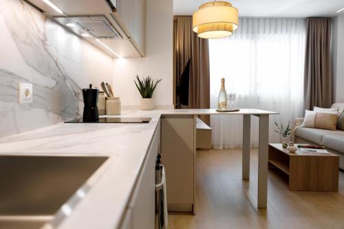 a kitchen and living room with a table and a couch at REM III Premium Torrevieja in Torrevieja
