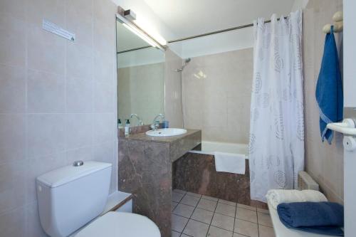 a bathroom with a toilet and a sink and a mirror at Sokoburu Deluxe Beach in Hendaye