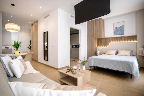 a bedroom with a bed and a living room at REM III Premium Torrevieja in Torrevieja