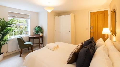 a bedroom with a white bed and a window at Newly Renovated 2-Bed Flat | Ripon Town Centre in Ripon