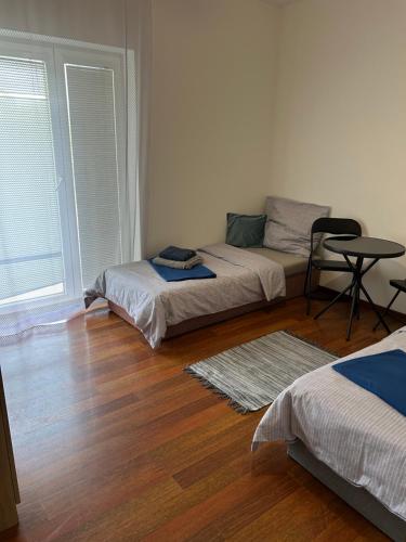 a room with two beds and a table in it at Sentio Inn 2 in Dunajská Streda