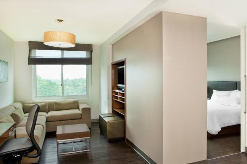 a living room with a bed and a couch at Element by Marriott Arundel Mills BWI Airport in Hanover