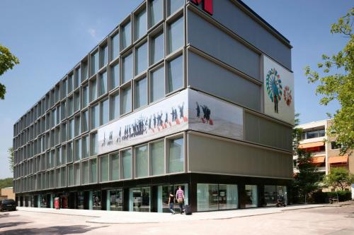 a building with a sign on the side of it at citizenM Amsterdam South in Amsterdam