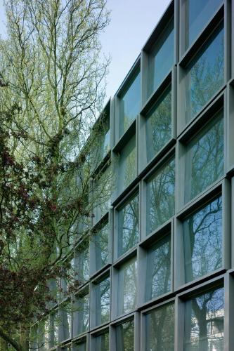 an office building with windows and trees at citizenM Amsterdam South in Amsterdam