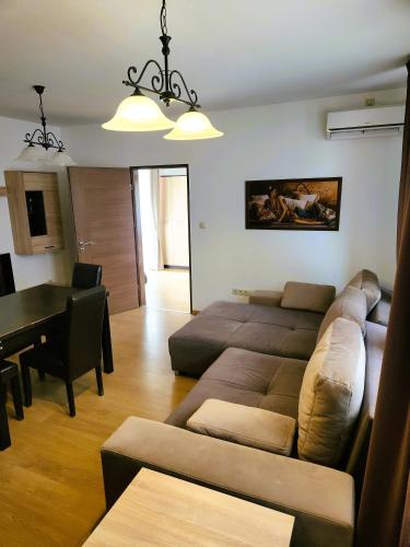 a living room with a couch and a table at Fortuna 7 in Hévíz