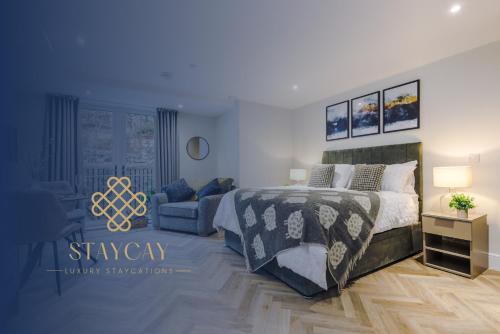 a bedroom with a bed and a couch at Rock Mill - Deluxe Studio Apartment with Balcony in Stony Middleton
