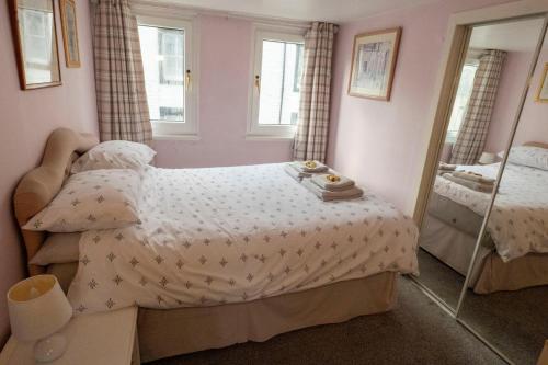 a bedroom with a bed and a mirror at 1BR Charming Cottage in Central Moffat in Moffat