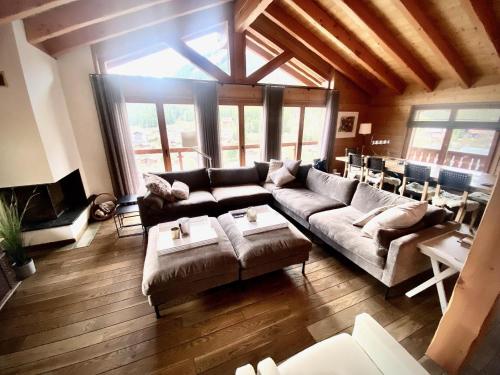 a living room with a couch and a table at Chalet Les Dalton, Morgins in Morgins