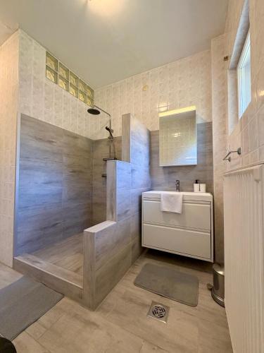 a bathroom with a shower and a sink and a tub at Müller's 1 in Siófok