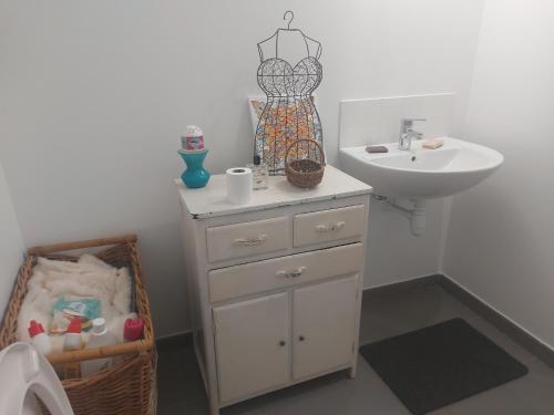 a bathroom with a sink and a white dresser at Coutances in Coutances