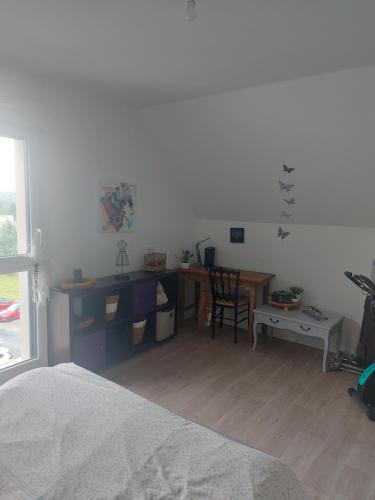 a bedroom with a desk and a table and a chair at Coutances in Coutances