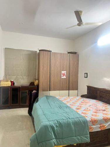 a bedroom with a bed and a wooden cabinet at Solace in Coimbatore