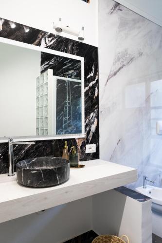 a bathroom with a sink and a mirror at Firmamento Royal House in Rocca Priora