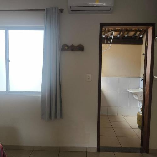 a bathroom with a mirror and a sink and a toilet at Pousada Vila Real Flats in Ouro Preto