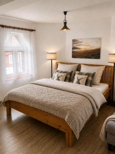 a bedroom with a large wooden bed with pillows at Apartmán Eskadra 1 in Horní Malá Úpa