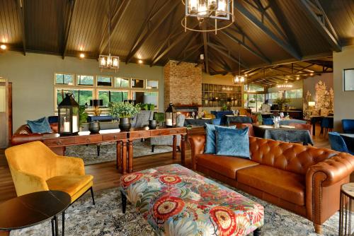 a lobby with a couch and chairs and a bar at Dunkeld East in Dullstroom