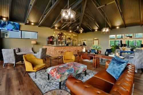 a lobby with a couch and chairs and a bar at Dunkeld East in Dullstroom