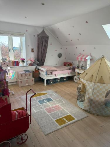 a room with a bedroom with a bed and a rug at Bondegård med havudsigt in Kolding