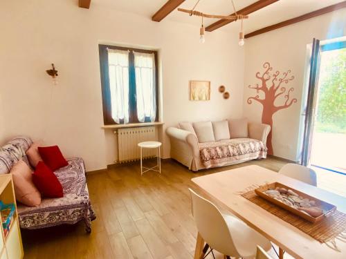 a living room with a couch and a table at La casa Rosa in Piobesi dʼAlba