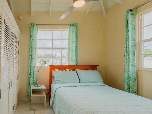 a bedroom with a bed and a window at Lunar Apartments in Saint Michael