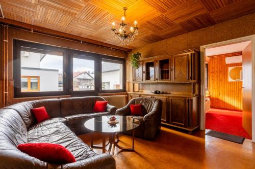 a living room with a couch and a table at Apartma v ograji in Šentjernej