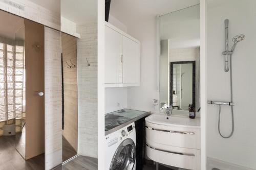 a white bathroom with a washing machine and a sink at L'Horizon by Cocoonr in Rennes