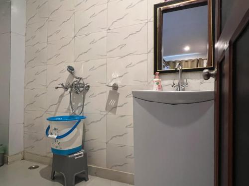 a bathroom with a sink and a toilet and a mirror at Magnetic Ridge Kasar in Hawālbāgh