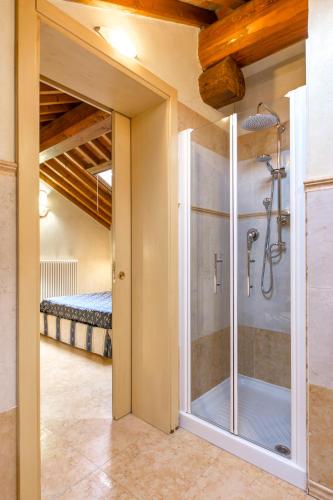a bathroom with a glass shower in a room at Locanda Modigliani in Ferrara