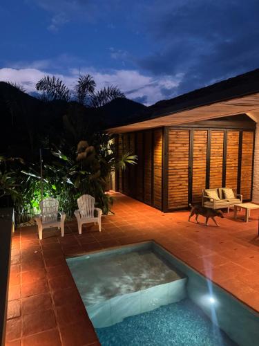a patio with a swimming pool in front of a house at Juntas del Lago - Casa 3 in Apulo