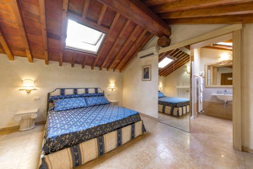 a bedroom with a bed and a sink in a room at Locanda Modigliani in Ferrara