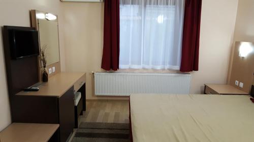 a hotel room with a bed and a window at Ego Guest House in Belogradchik