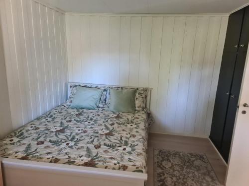 a bed with two pillows on it in a room at Søvikhus in Haram