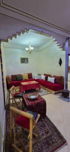 a living room with red couches and a rug at Cozy in Midelt - Downtown apartment in Midelt