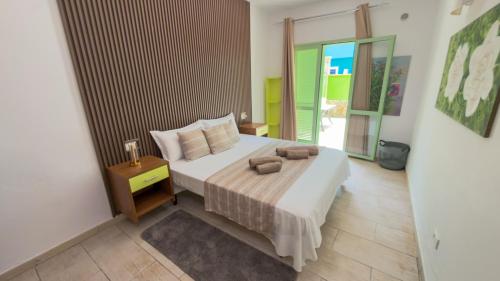 a bedroom with a bed with two towels on it at InkHouse C02 in Santa Maria