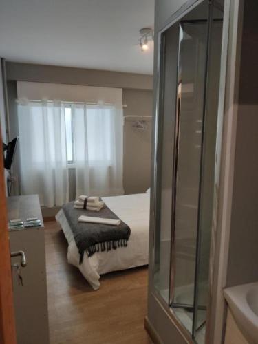 a bathroom with a bed in a room at Ecorooms SCQ estación in Santiago de Compostela