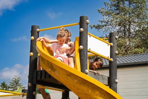 two children playing on a slide at a playground at Arden Parks Tulderheyde in Poppel