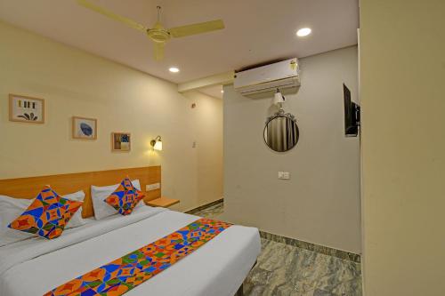 a bedroom with two beds and a ceiling fan at FabHotel Casa Grand Ecil in Hyderabad