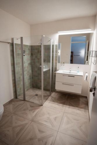 a bathroom with a shower and a sink at Hotel Lethehof in Wardenburg