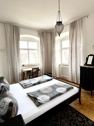 a bedroom with two large beds in a room at FeWo Seliger am Schloßplatz in Meersburg