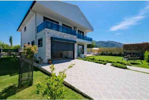 a large white house with a large driveway at Villa Kalinda Your Private Sheltered Luxury Villa with Pool Minutes Away from Dalaman Airport in Dalaman