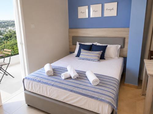 a bedroom with a bed with white towels on it at Proteas Mare Suites in Protaras