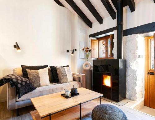a living room with a couch and a fireplace at El Nido Rural Boutique Villa in La Focella